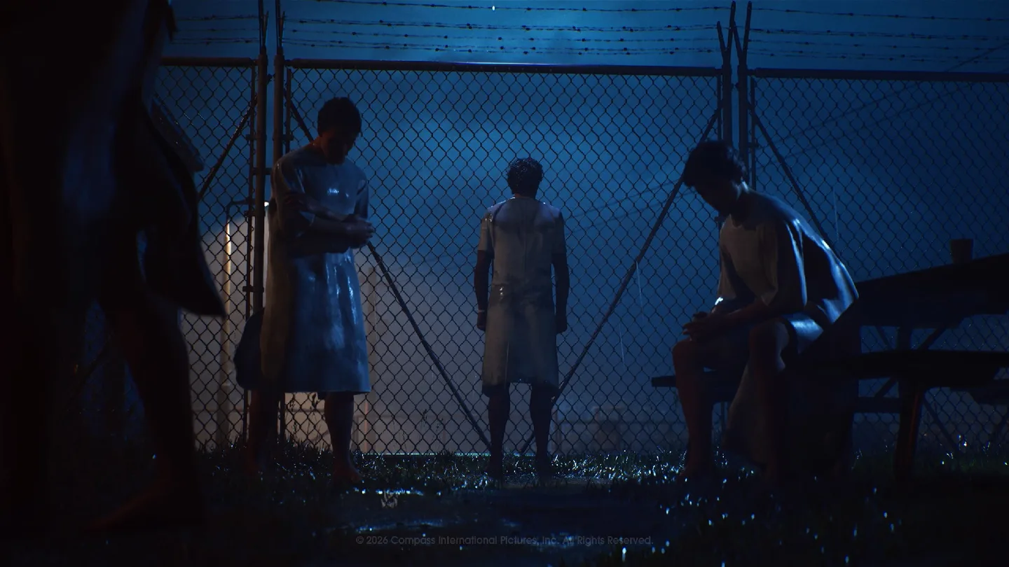 Patients crowd behind a fence at Smith's Grove Sanitarium in an official story still.